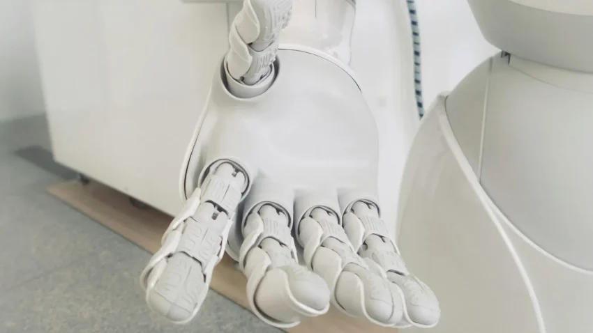 Close-up of a robot hand reaching out, illustrating why AI does not trust your content and the challenge of building trust with AI systems.